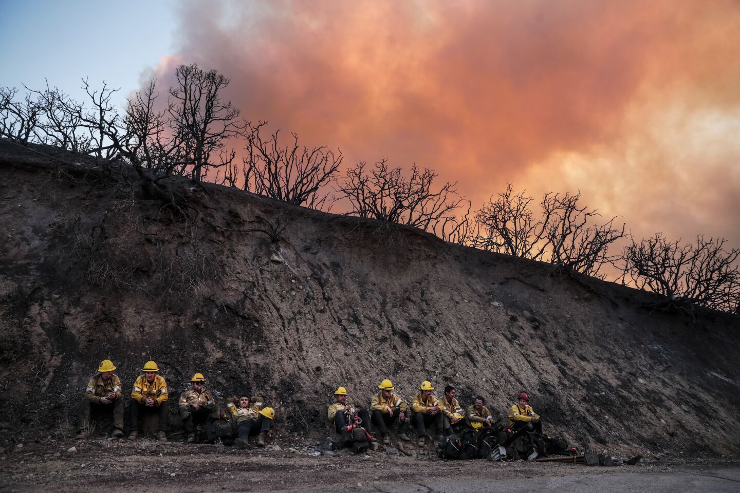 A crew rests as the Bobcat fire burns