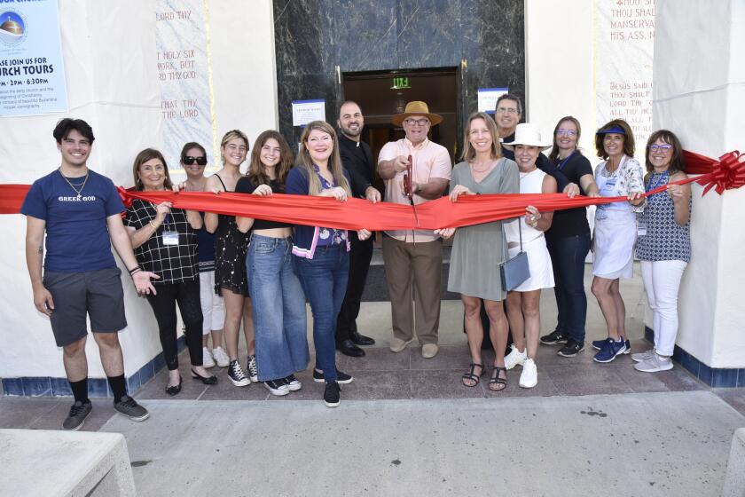 Encinitas Mayor Tony Kranz cuts the ribbon to open the 2023 Greek Festival, assisted by Assemblywoman Tasha Boerner and Senator Catherine Blakespear and church members