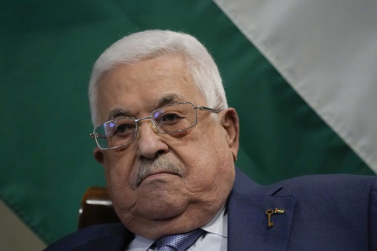 Mahmoud Abbas with a flag as a backdrop. 