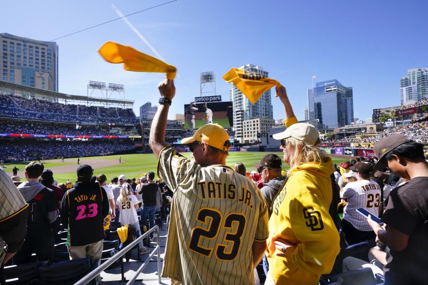 San Diego, CA - March 28: Colin and his wife, Jane Ross of downtown's East Village cheered on the San Diego Padres in the 7th inning. The Padres got the win against the San Francisco Giants at their home opener at Petco Park on Thursday, March 28, 2024. (Nelvin C. Cepeda / The San Diego Union-Tribune)