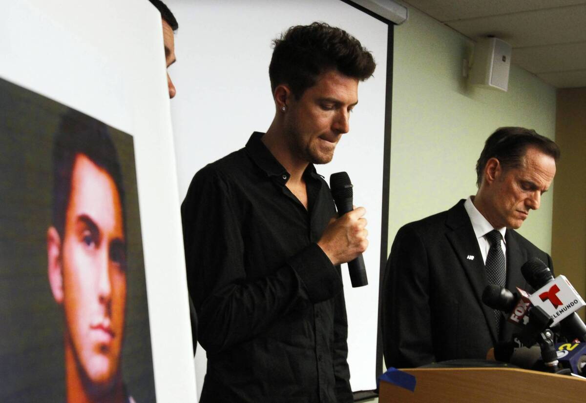 Casey Hayden speaks about his partner Rjay Spoon, in photo at left, who died of bacterial meningitis, as Michael Weinstein, right, president of the AIDS Healthcare Foundation listens during a news conference in West Hollywood.