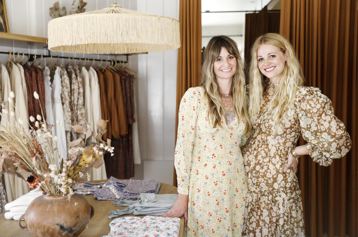 Sisters Margaret and Katherine Kleveland wear flowy, flowery dresses at their store, Dôen.