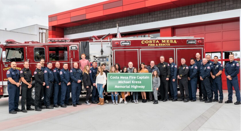 Family members of Capt. Mike Kreza with Costa Mesa fire fighters in a Feb. 21 unveiling ceremony.