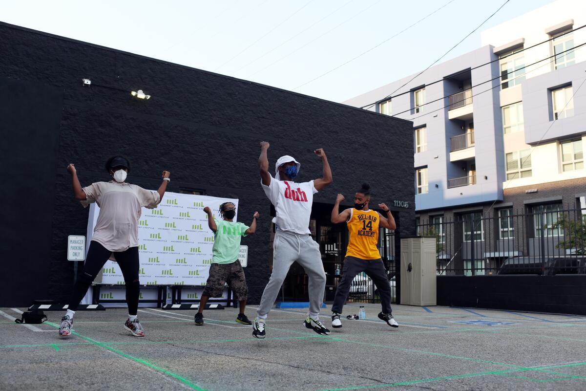 Instructor Joe Brown leads a dance class in a parking lot at Movement Lifestyle Studio in North Hollywood