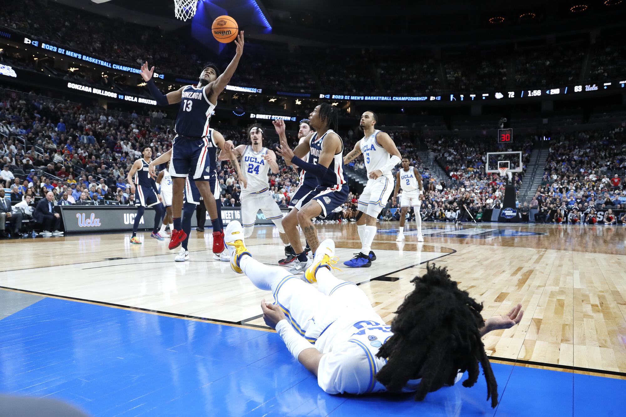 Gonzaga guard Malachi Smith rebounds a missed shot by UCLA guard Tyger Campbell.