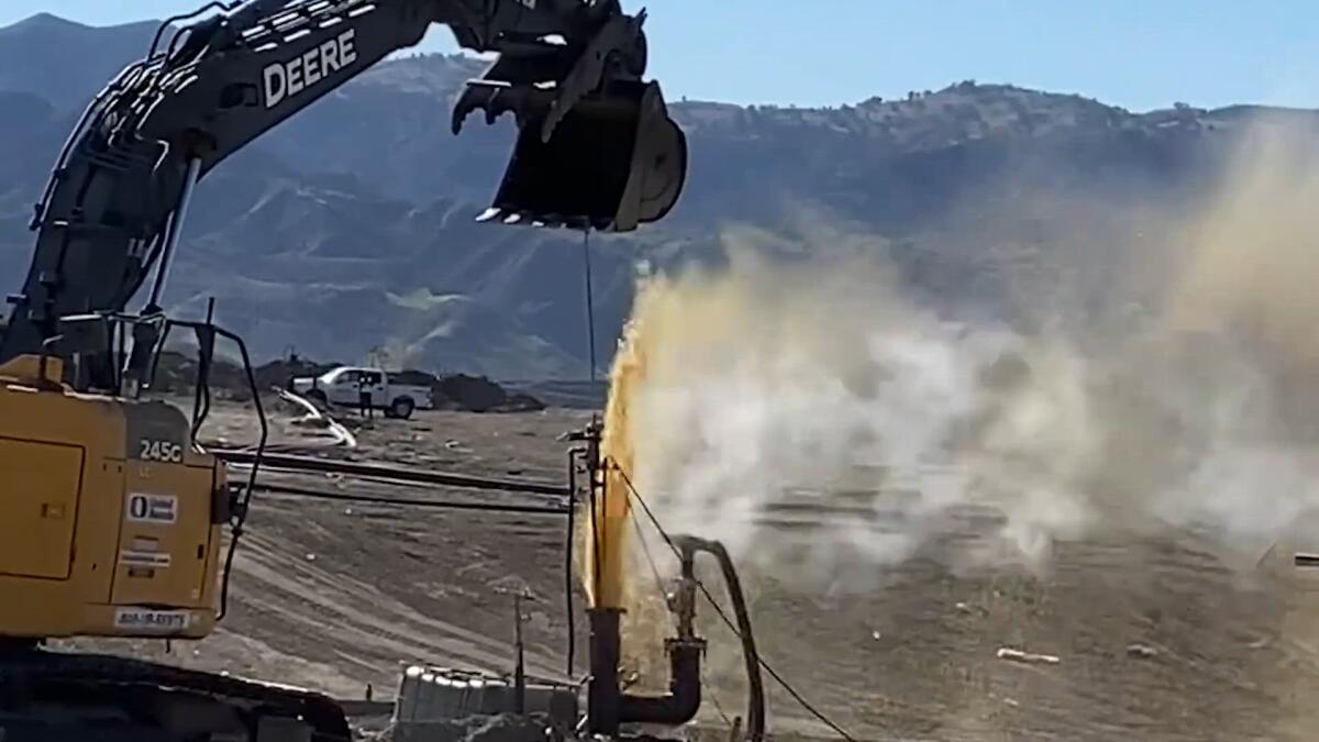 Polluted water bursts onto the surface at a landfill.