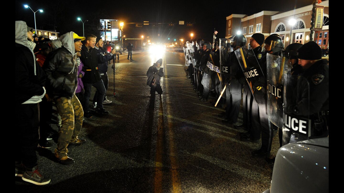 Protesters square off with police officers during a demonstration outside the Ferguson police station in Missouri Nov. 19.
