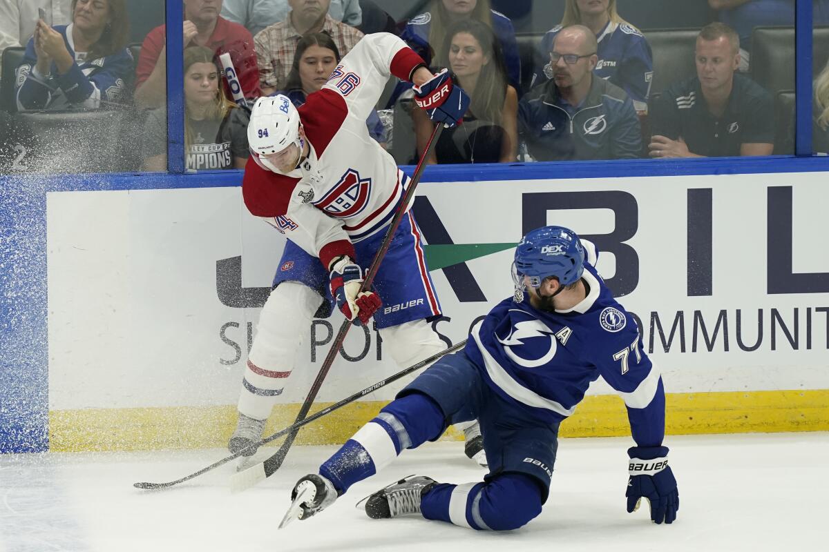 Montreal's Corey Perry (94) controls the puck next to Tampa Bay's Victor Hedman (77) in the first period.