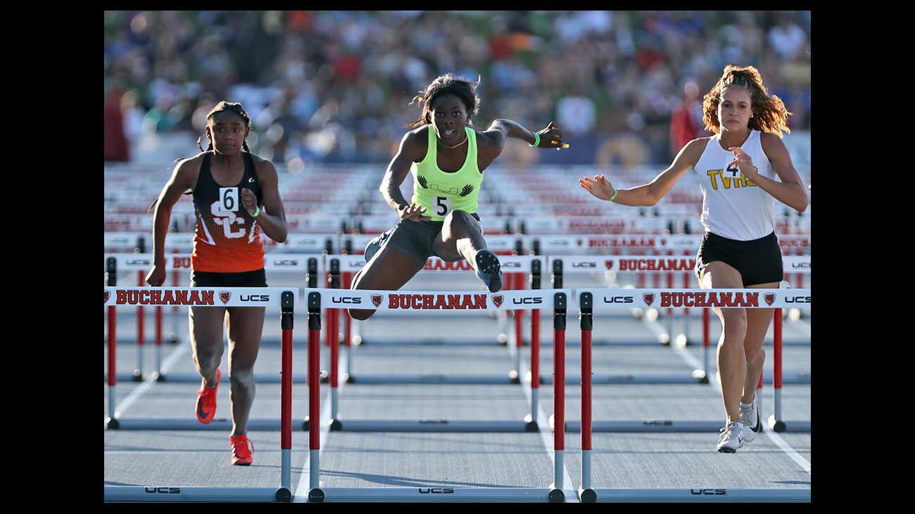 Upland High School runner Jada Hicks, center, wins the state championship in the girls 100 meter hurdles at the 100th CIF State track & field championships, at Buchanan High School Veterans Memorial Stadium, in Clovis, Ca., on Saturday, June 2, 2018.