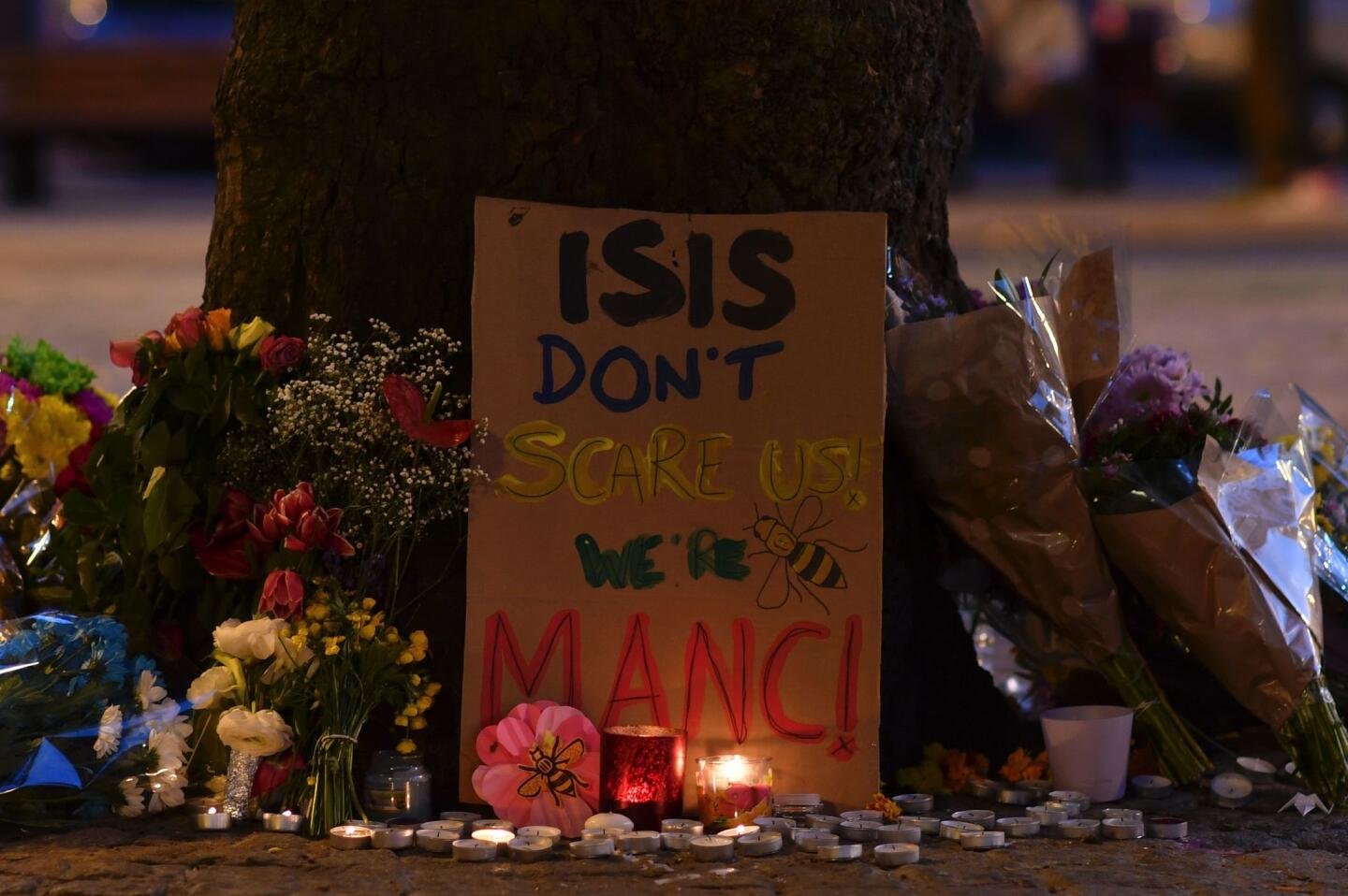 Messages and floral tributes are seen in Albert Square in Manchester, England, on May 23, 2017, in solidarity with those killed and injured in the previous day's terror attack at an Ariana Grande concert.