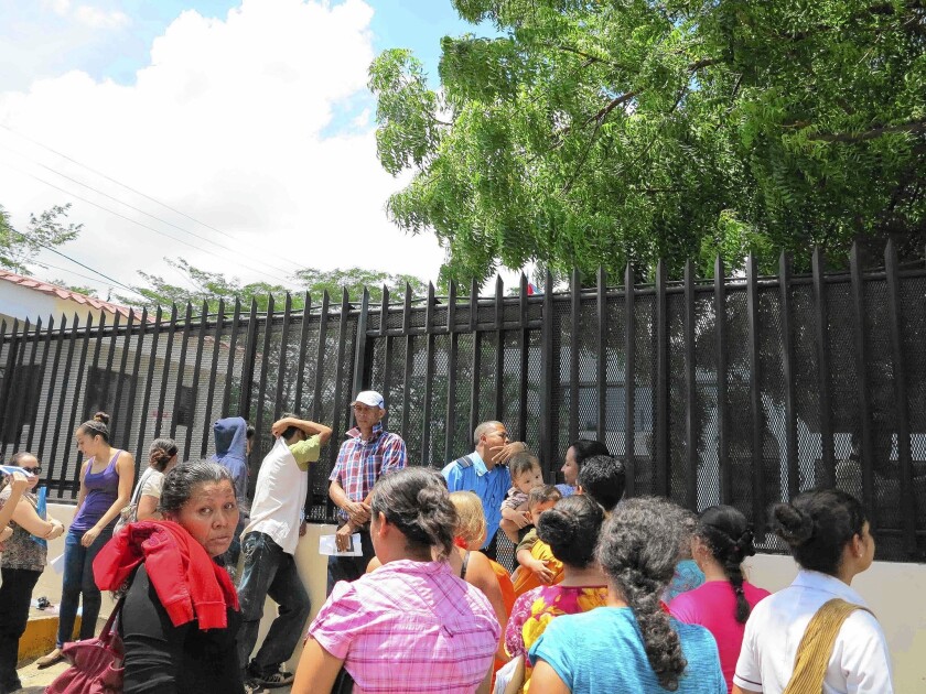 A small crowd gathers outside the Costa Rican consulate in Managua, Nicaragua on Aug. 8, 2014. Most weekdays see scores of Nicaraguans seeking a Costa Rican visa.