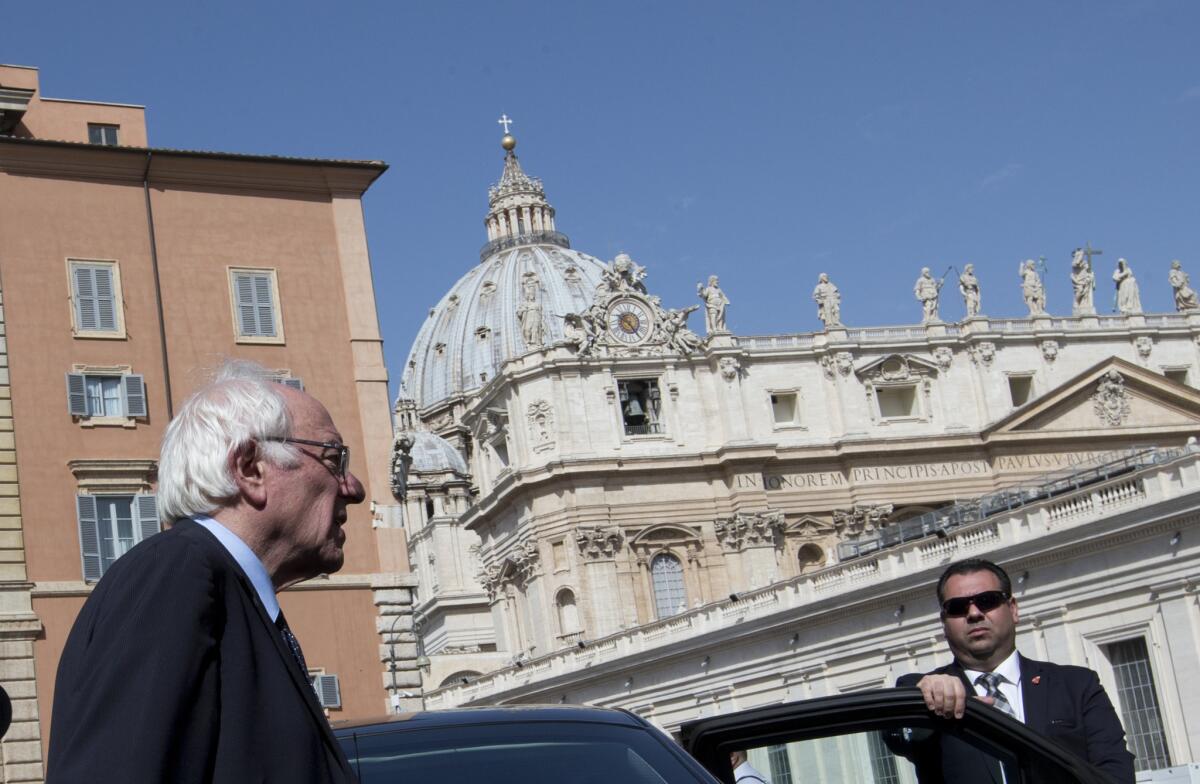 Sen. Bernie Sanders, backdropped by the dome of St. Peter's Basilica, leaves after an interview with the Associated Press at the Vatican.