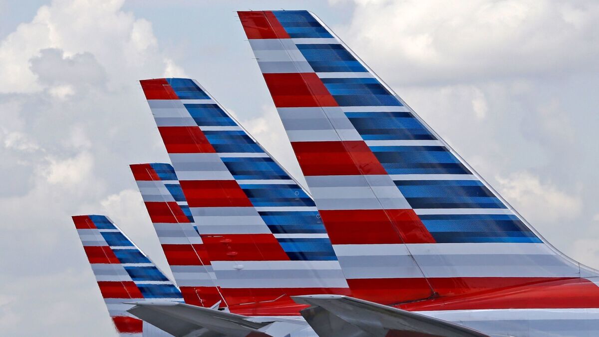 Four American Airlines passenger planes parked at Miami International Airport in 2015.