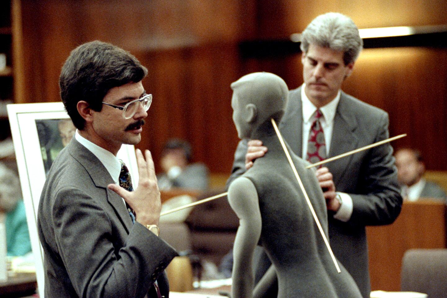 Medical Examiner Christopher Swalwell, left, shows the path of bullets that killed Linda Broderick as prosecutor Paul Burakoff looks on in Betty Broderick's retrial on Oct. 16, 1991.