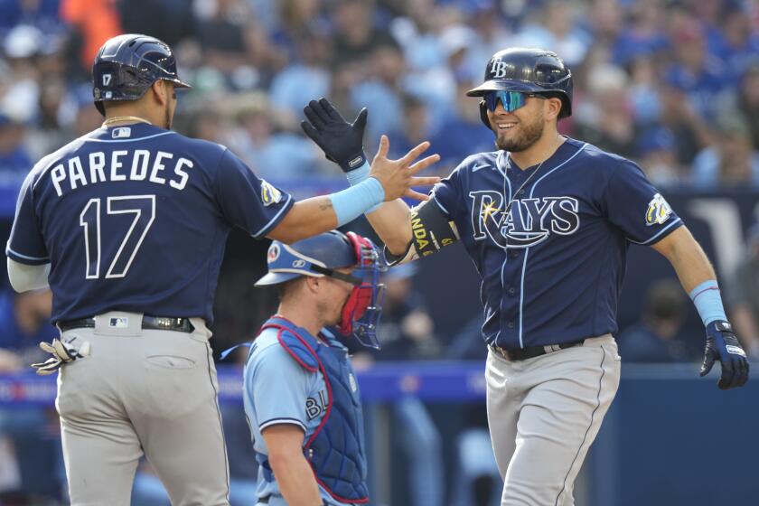 Tampa Bay Rays' Jonathan Aranda, right, celebrates after his grand slam with teammate Isaac Paredes (17) during second-inning baseball game action against the Toronto Blue Jays in Toronto, Sunday, Oct. 1, 2023. (Frank Gunn/The Canadian Press via AP)