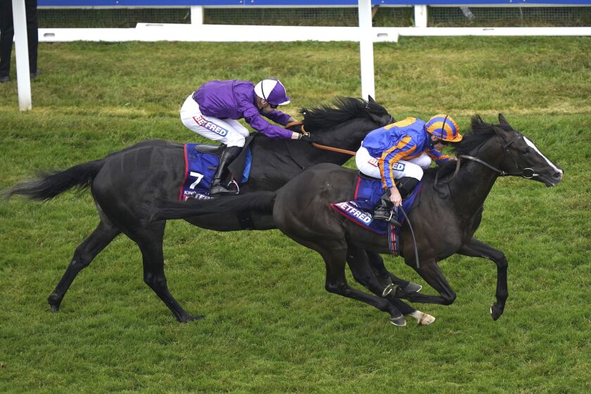 Jockey Ryan Moore with Auguste Rodin, ahead of King of Steel ridden by jockey Kevin Stott, wins the Derby at the 2023 Derby Festival at Epsom Downs Racecourse, Epsom, England, Saturday June 3, 2023. (Victoria Jones/PA via AP)