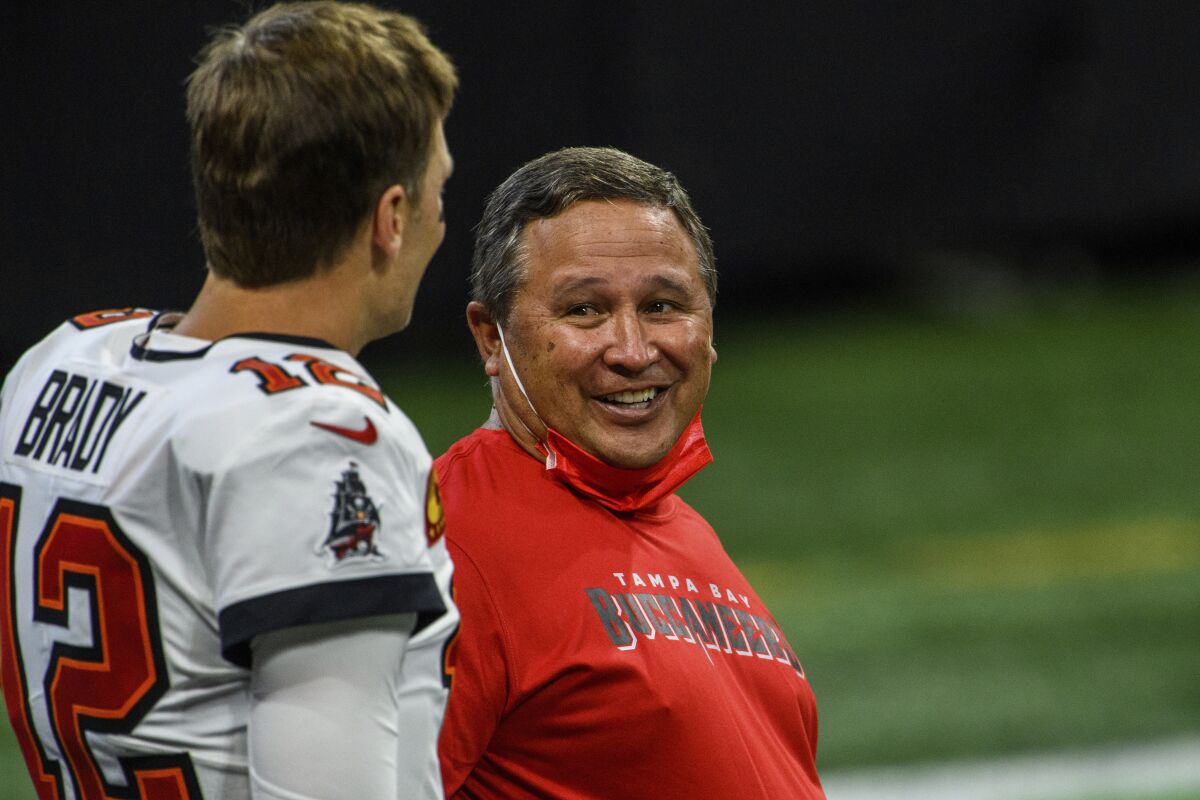 Buccaneers quarterbacks coach Clyde Christensen talks with Tom Brady before a game.