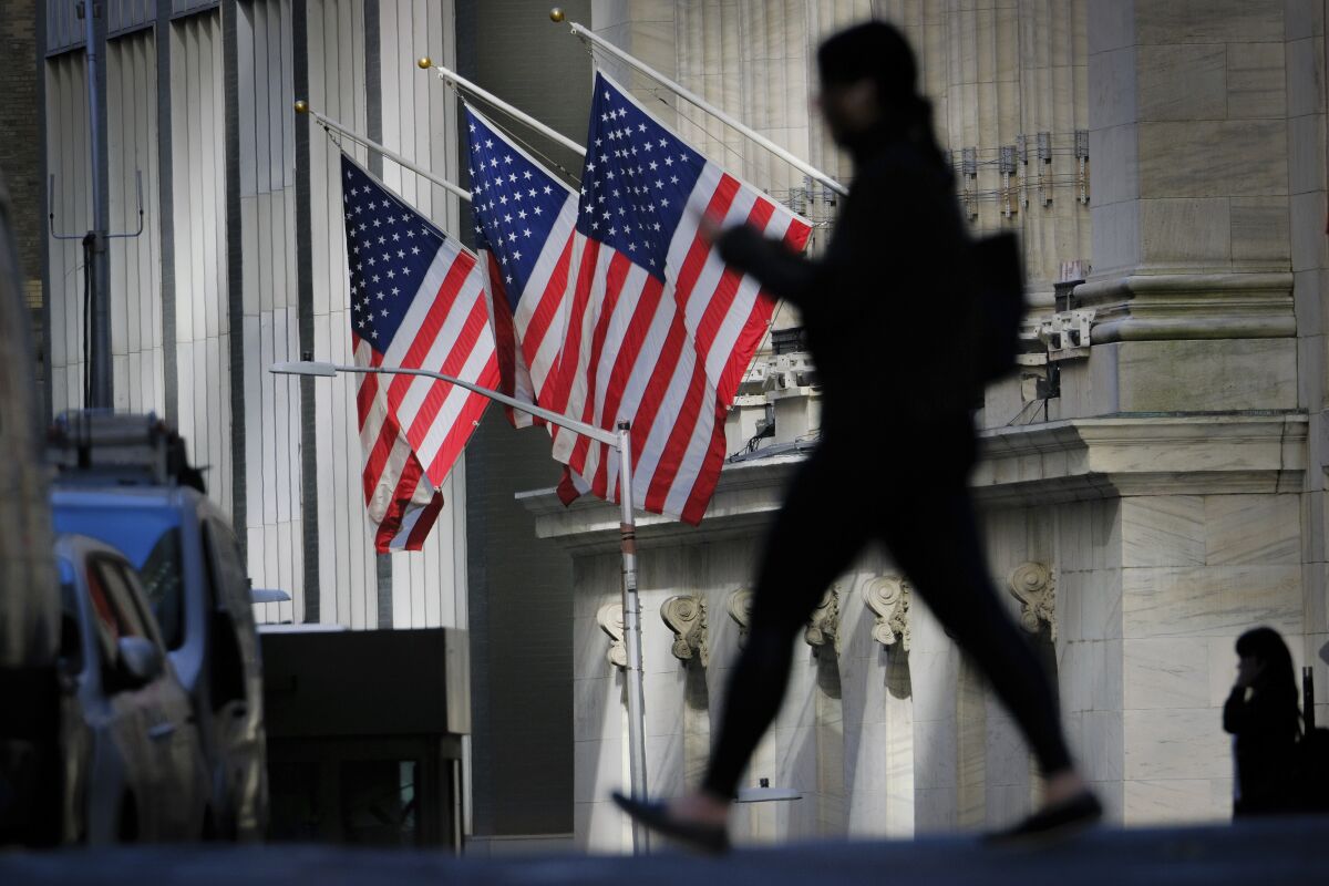 A pedestrian walks past the New York Stock Exchange in 2022.