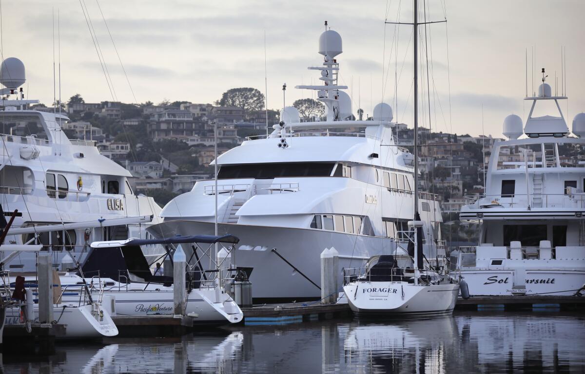 The 145-foot superyacht Dumb Luck, center, is docked in Shelter Island basin.