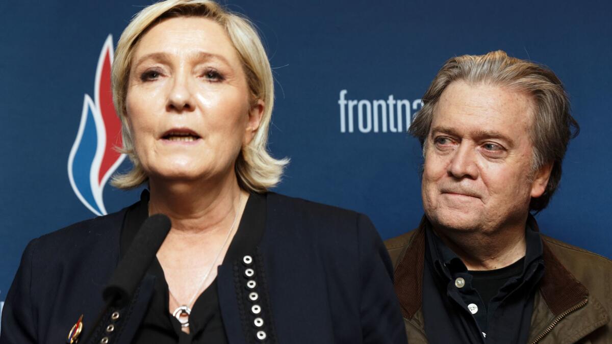 National Front leader Marine Le Pen speaks at the party's annual congress in Lille, France, as former Trump advisor Stephen K. Bannon stands behind her.
