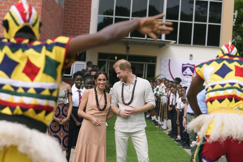 Prince Harry and Meghan visit children at the Lights Academy in Abuja, Nigeria, Friday, May 10, 2024. Prince Harry and his wife Meghan have arrived in Nigeria to champion the Invictus Games, which he founded to aid the rehabilitation of wounded and sick servicemembers and veterans. (AP Photo/Sunday Alamba)