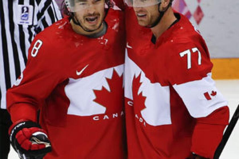 Drew Doughty, left, and Jeff Carter aren't fans of the wider Olympics ice.