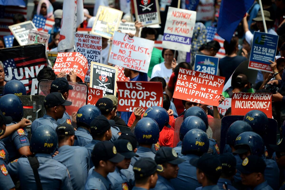 Activists protest in front of the U.S. Embassy in Manila on Wednesday against an expected accord that would increase the U.S. military presence in the island nation.