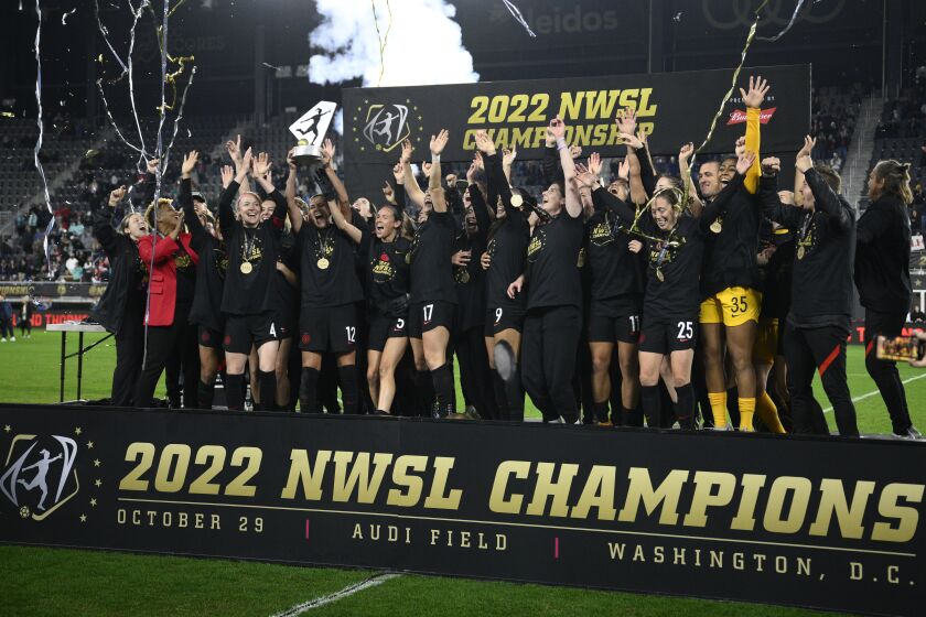 Portland Thorns FC celebrates with the trophy after winning the NWSL championship game against the Kansas City Current