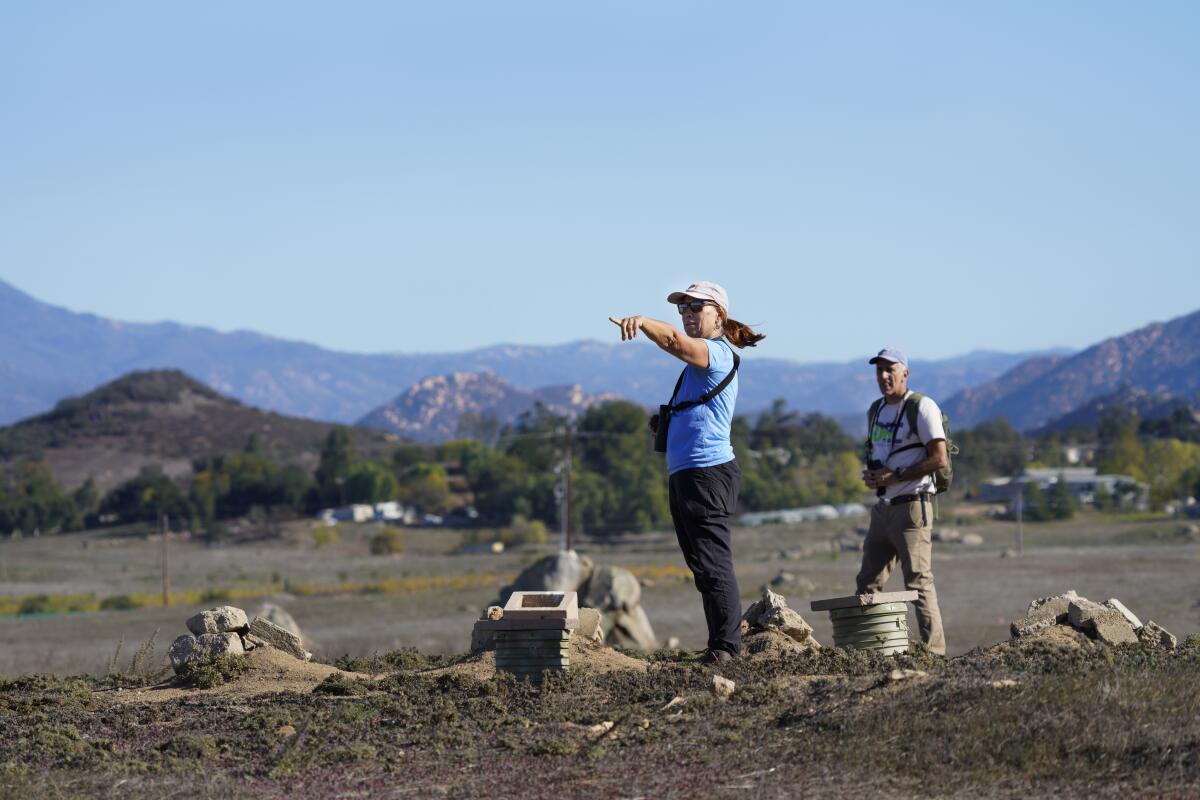  in Ramona, CA., Christina Schaefer and Don Scoles from a distance scout out their next burrowing owl nesting site 