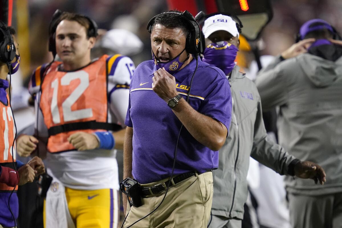 LSU coach Ed Orgeron talks to staff on the sideline at Texas A&M on Nov. 28.