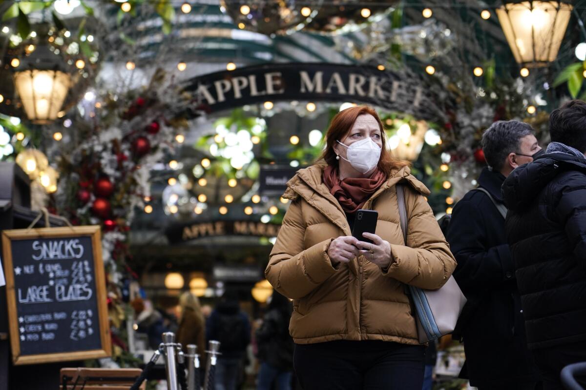 A woman wearing a face mask shops at Covent Garden 