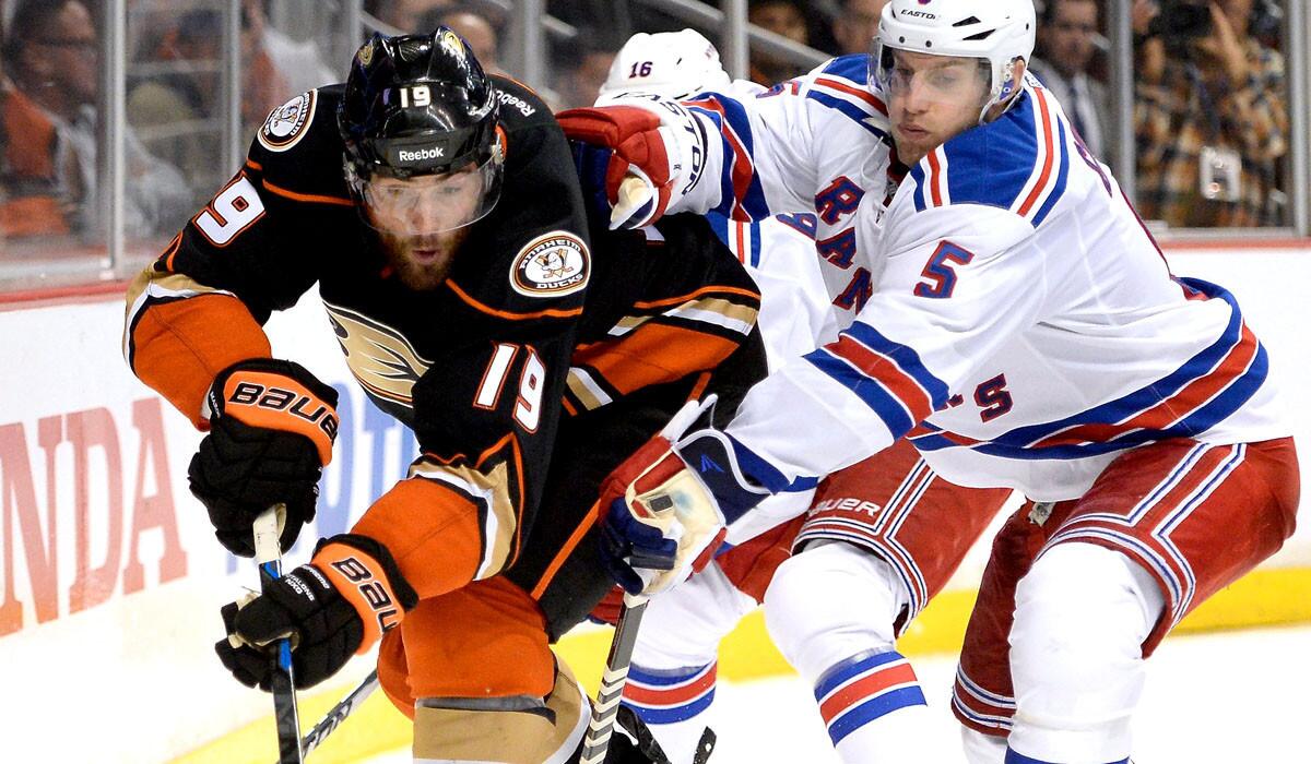 Ducks left wing Patrick Maroon tries to control the puck against Rangers defenseman Dan Girardi during their game Wednesday in Anaheim.