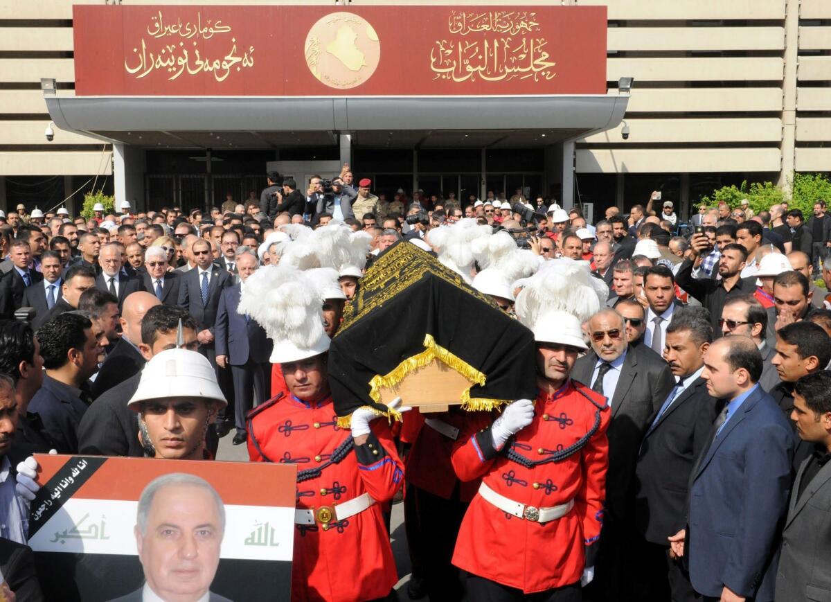 Honor guards carry the coffin of Ahmad Chalabi during his funeral at the headquarters of Iraqi parliament in Baghdad on Nov. 4. Chalabi was a key mover behind the US-led invasion of Iraq in 2003.