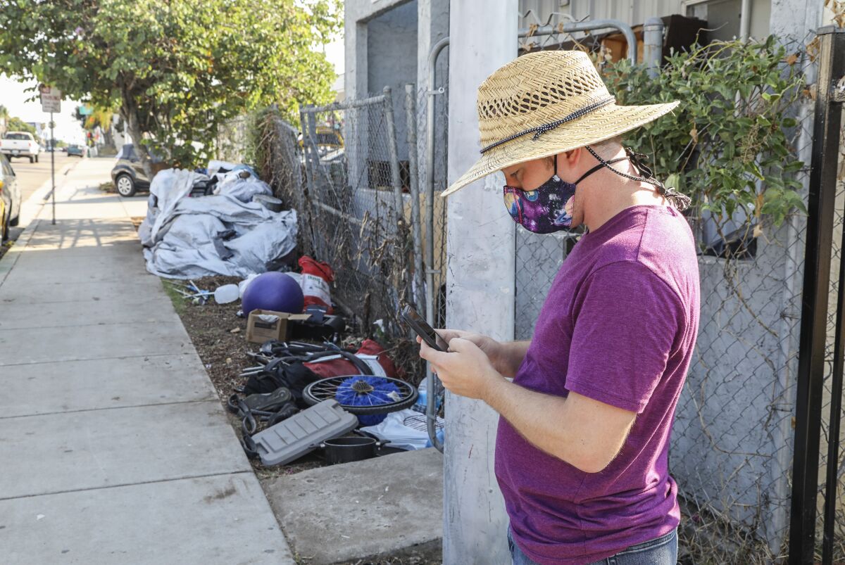 James Lively reports a trash dump with the Get it Done app while in City Heights.