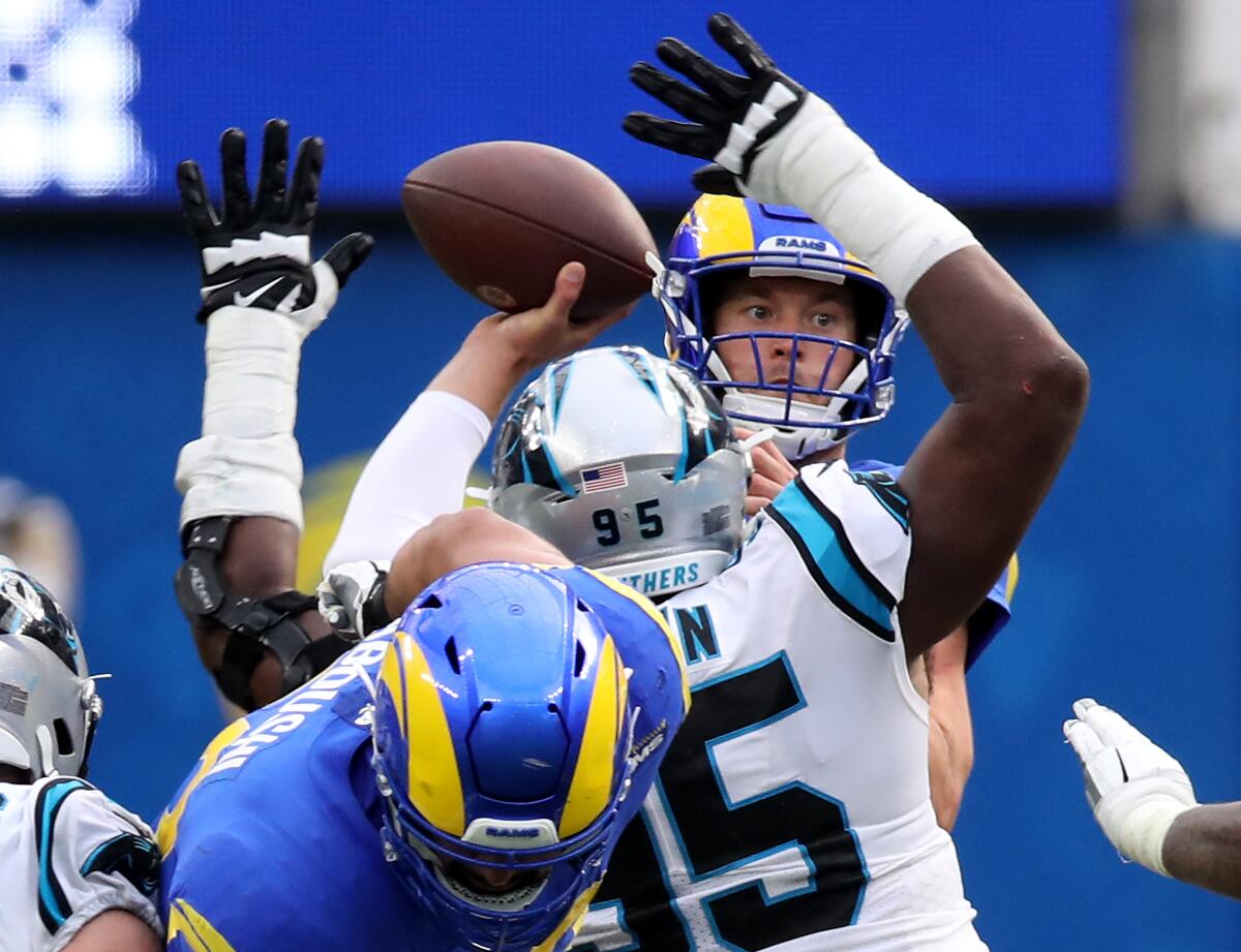 Rams quarterback Matthew Stafford passes under pressure from the Carolina defense