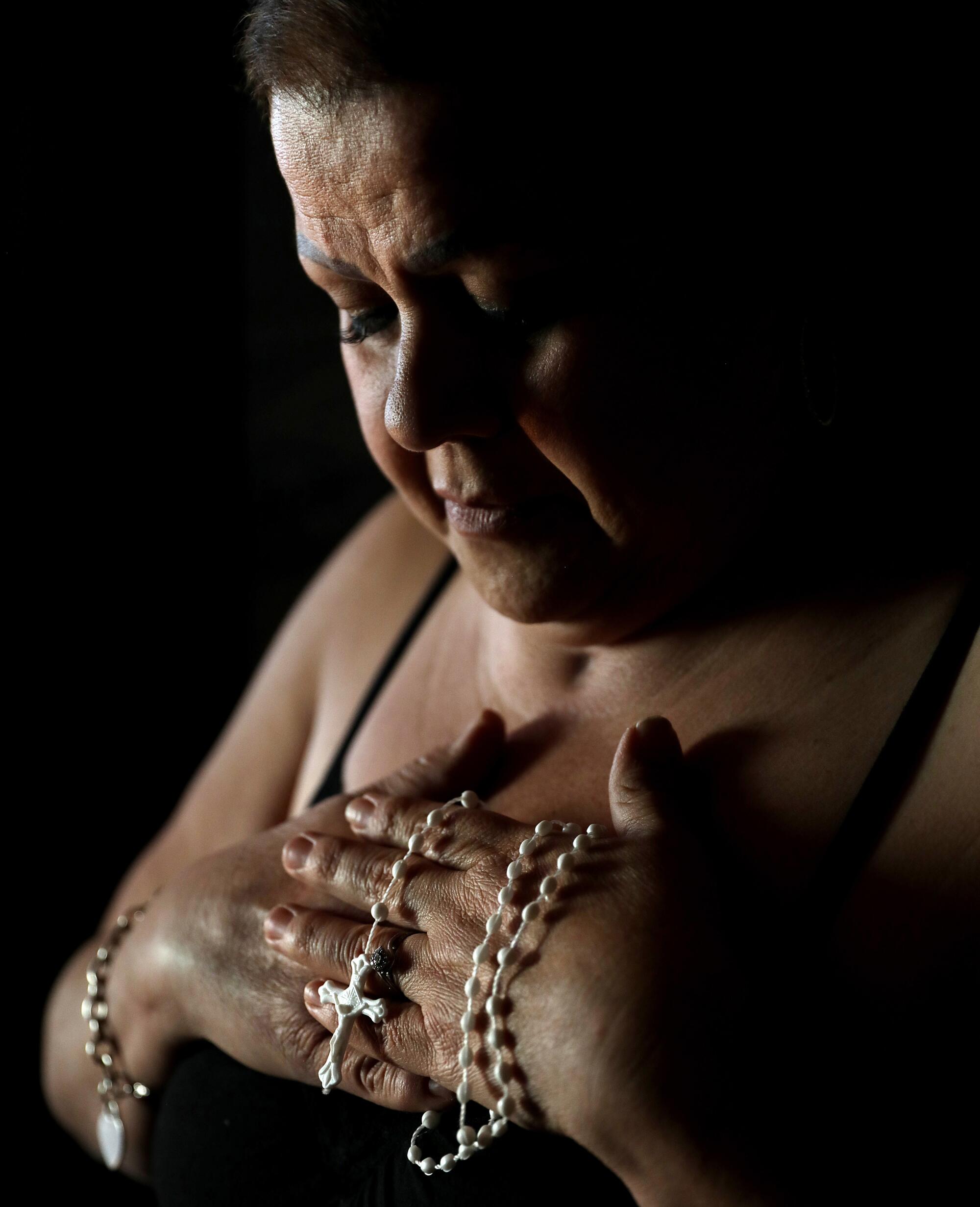  Blanca Lopez holds a rosary.  