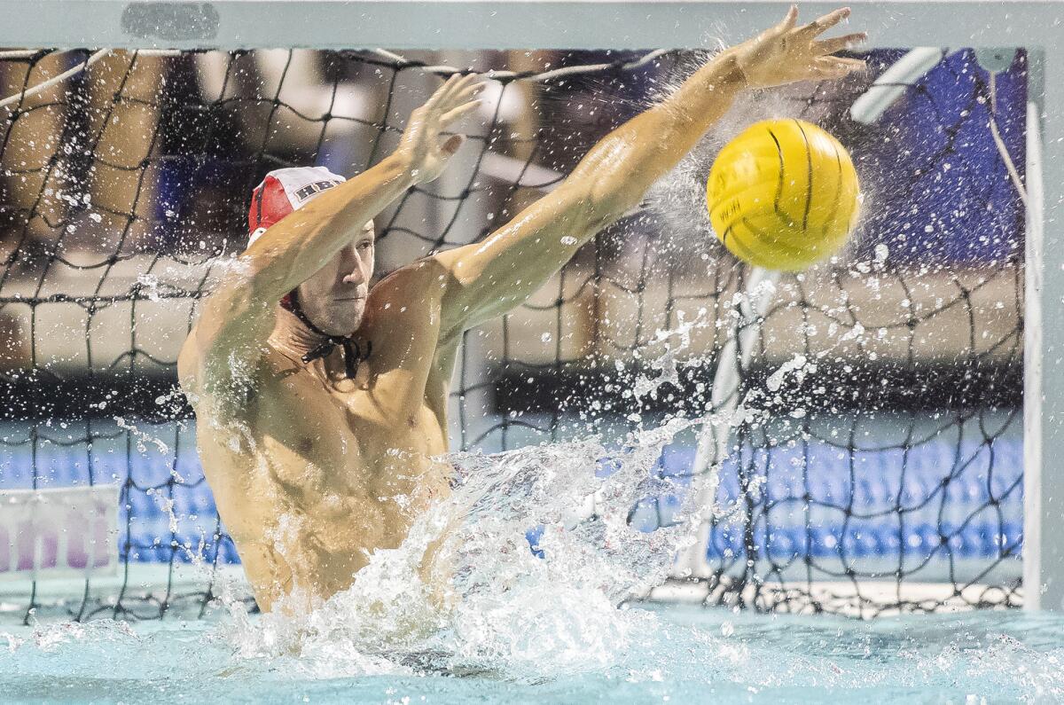 Huntington Beach goalkeeper Jacob Pyle blocks an Orange Lutheran shot in the first round of the CIF Southern Section Division 1 playoffs at Santiago Canyon College in Orange on Thursday.