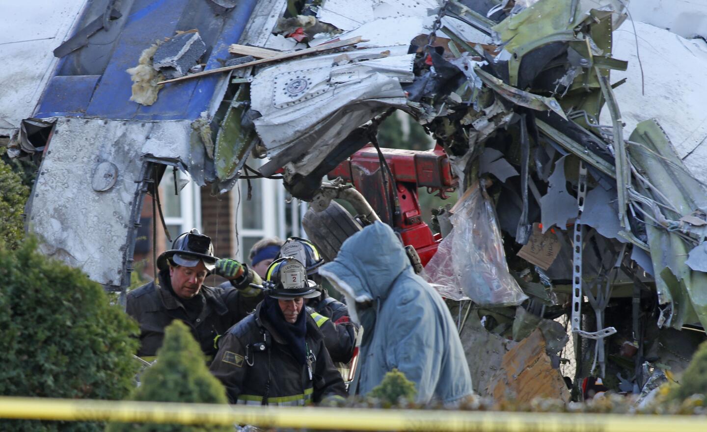The plane that crashed early Tuesday in the 6500 block of South Knox Avenue near Midway Airport is slowly pulled away from the home it crashed into. The aircraft was lowered, cut apart and removed.
