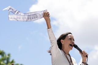 Opposition leader Maria Corina Machado displays vote tally sheets during a protest against the reelection of President Nicolás Maduro one month after the disputed presidential vote which she says the opposition won by a landslide, in Caracas, Venezuela, Wednesday, Aug. 28, 2024. (AP Photo/Ariana Cubillos)