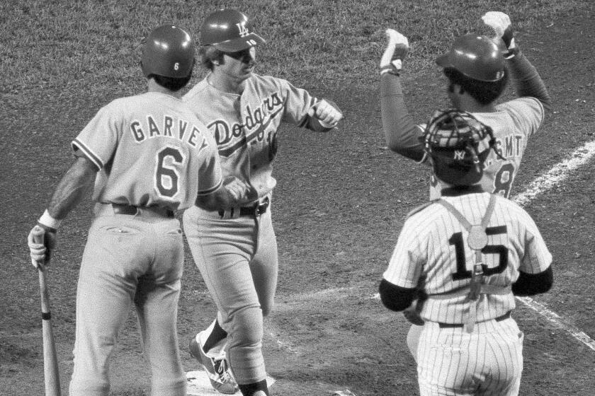 Dodgers' Ron Cey is congratulated by teammates Steve Garvey , left, and Reggie Smith.