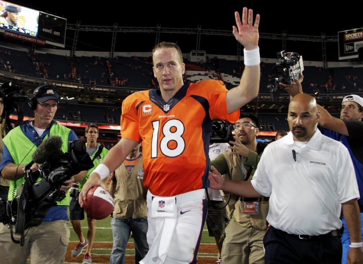 Quarterback Peyton Manning walks off the field after throwing seven touchdown passes in Thursday's NFL opening game in Denver.