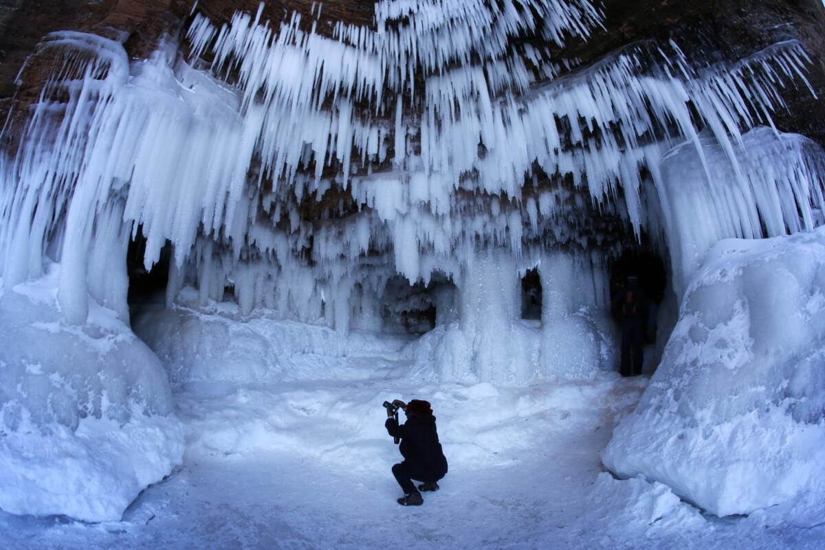 A visitor attempts to capture the wonder of a frozen cave at Apostle Islands National Lakeshore in northern Wisconsin.