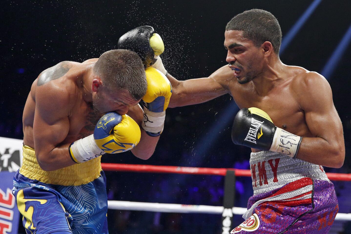 Vasyl Lomachenko tries to slip a punch by Gamalier Rodriguez during their featherweight title fight in Las Vegas.