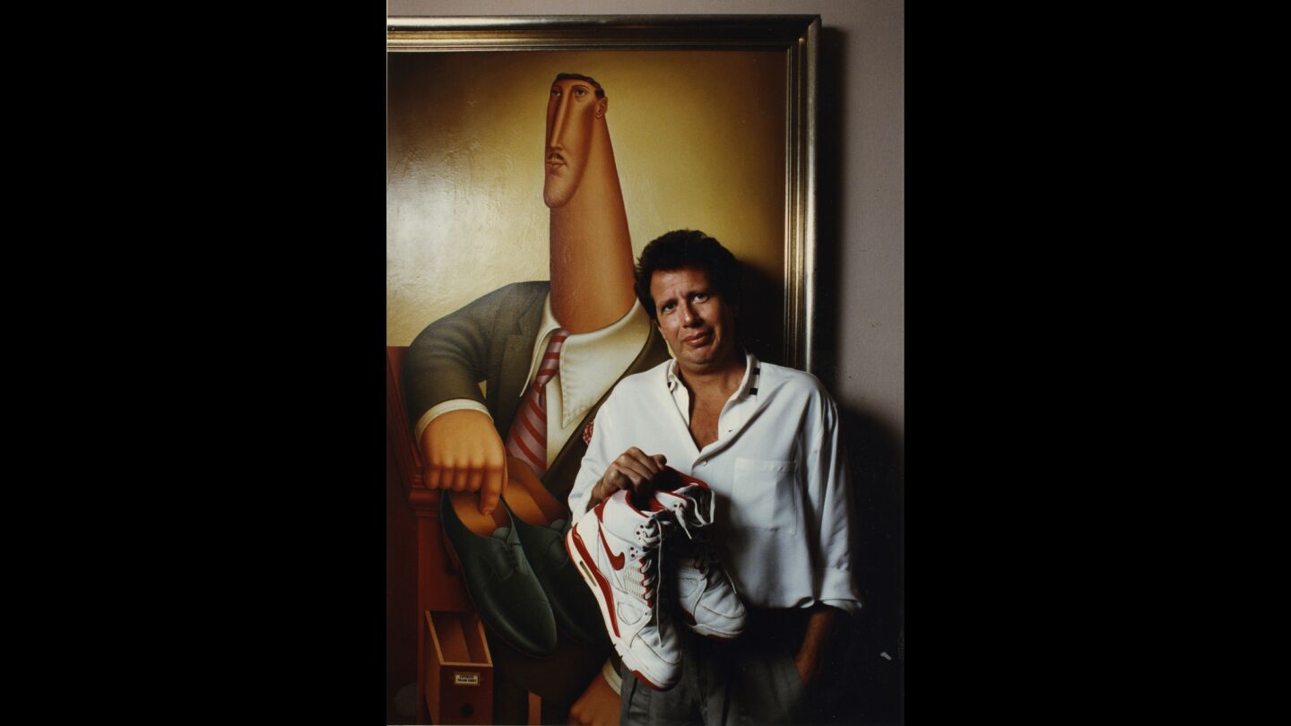 Garry Shandling poses in front of a painting in his management office.