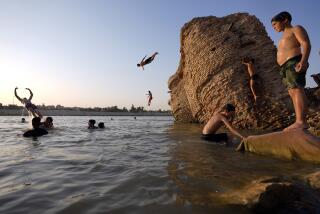 Iraqis swim in the Tigris River to beat the heat in Baghdad, Iraq, Thursday, July 13, 2023. (AP Photo/Hadi Mizban)