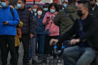 Residents wearing face masks wait in line to get their routine COVID-19 throat swabs tests at a coronavirus testing site in Beijing, Tuesday, Oct. 25, 2022. (AP Photo/Andy Wong)