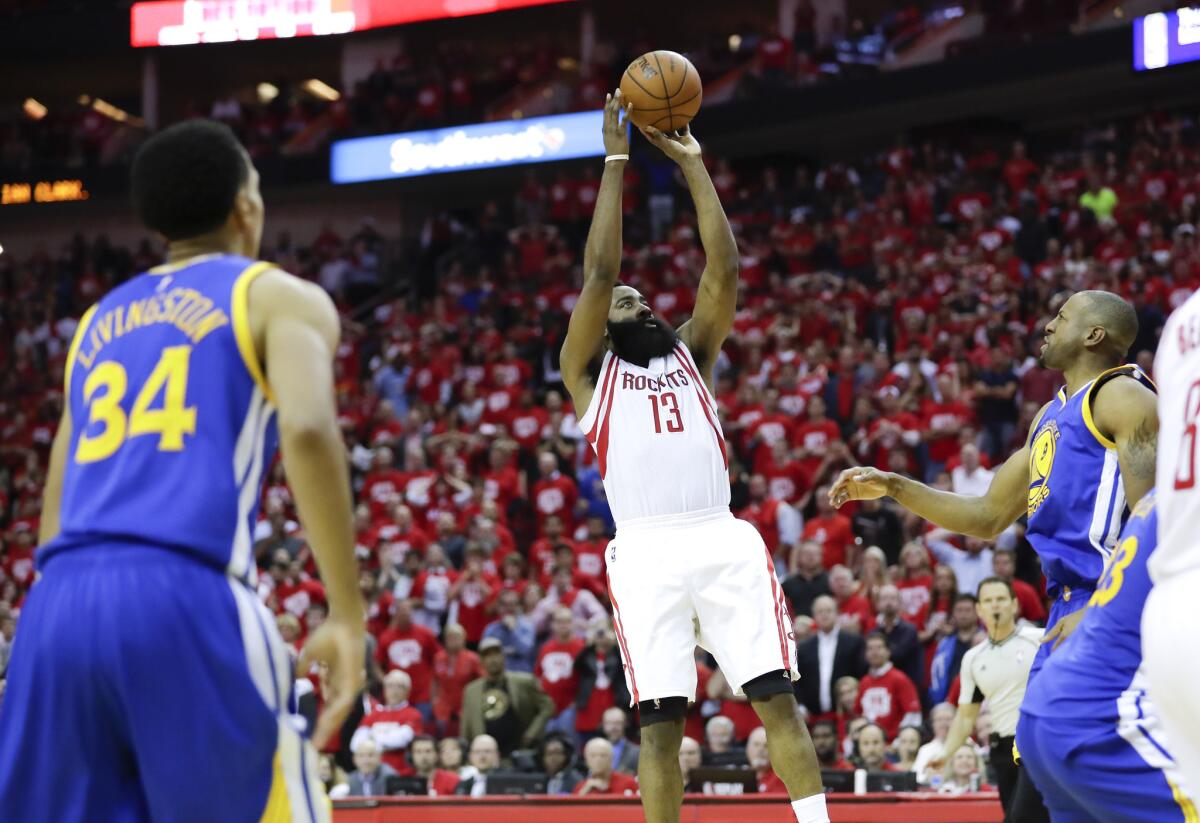 Rockets guard James Harden scores the winning basket against the Golden State Warriors in the final seconds of Game 3.