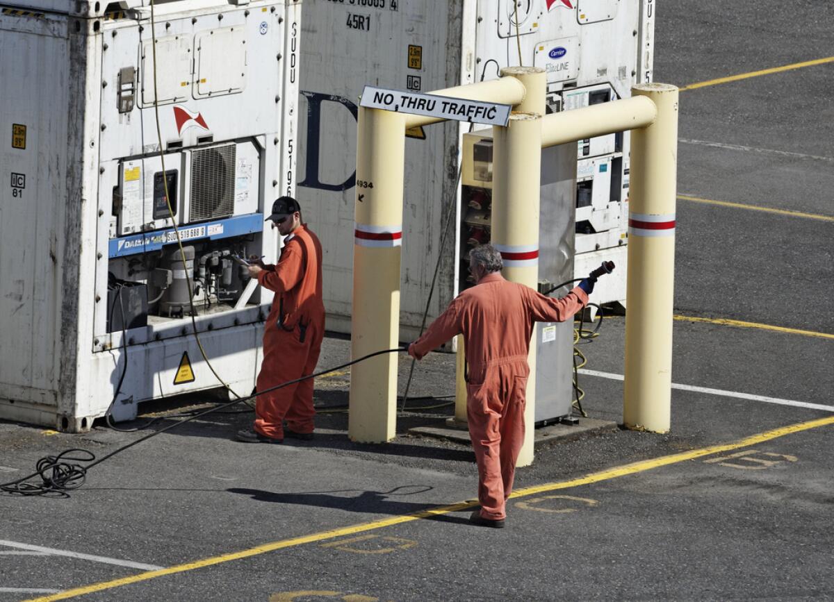 Electricians in contested jobs at the Port of Portland tend containers in 2012.