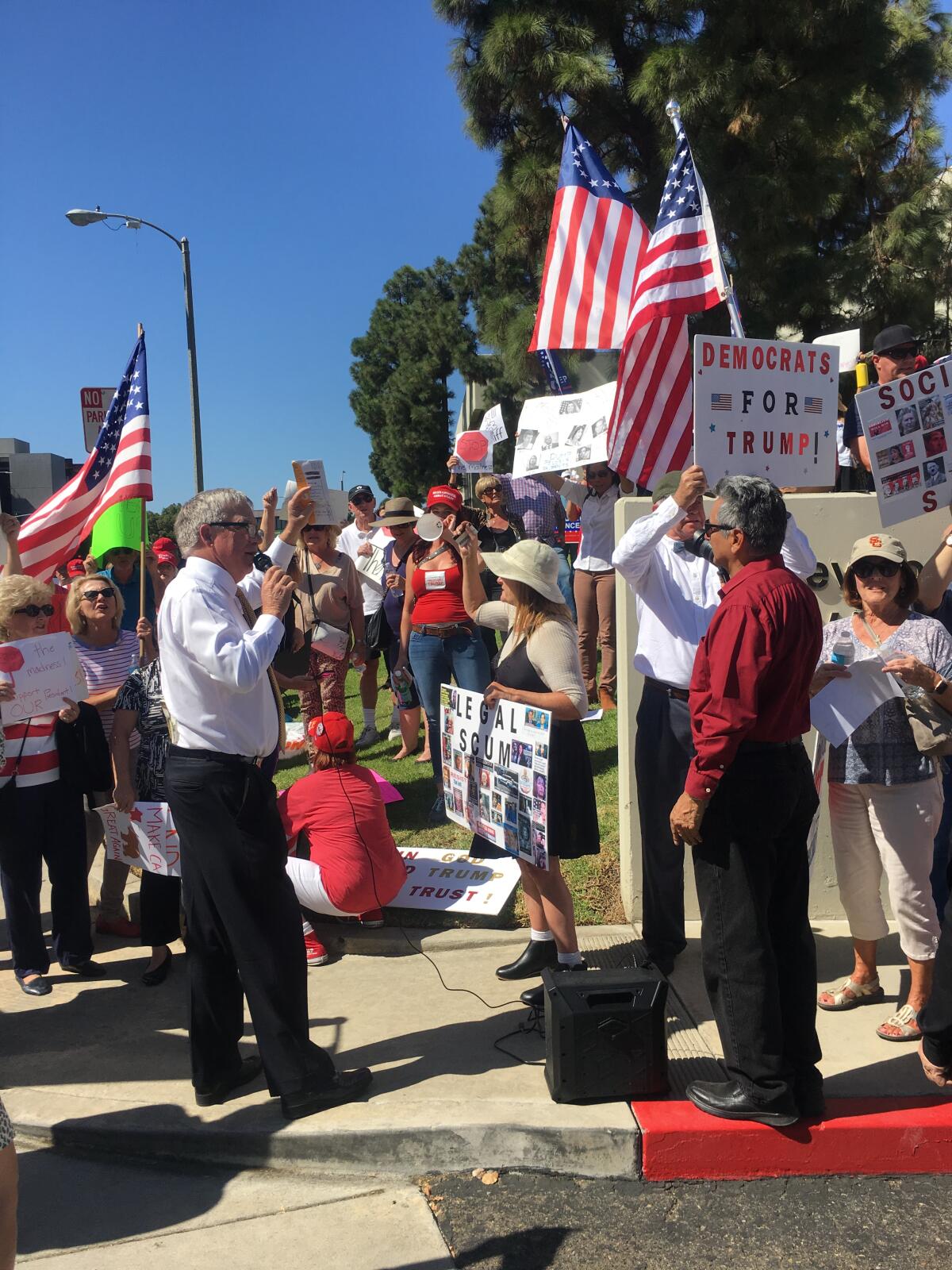 Doug Ose, a former U.S. Representative from Northern California and Donald Trump's 2016 California chairman, addresses a rally outside Democratic Rep. Katie Porter's office in Irvine.