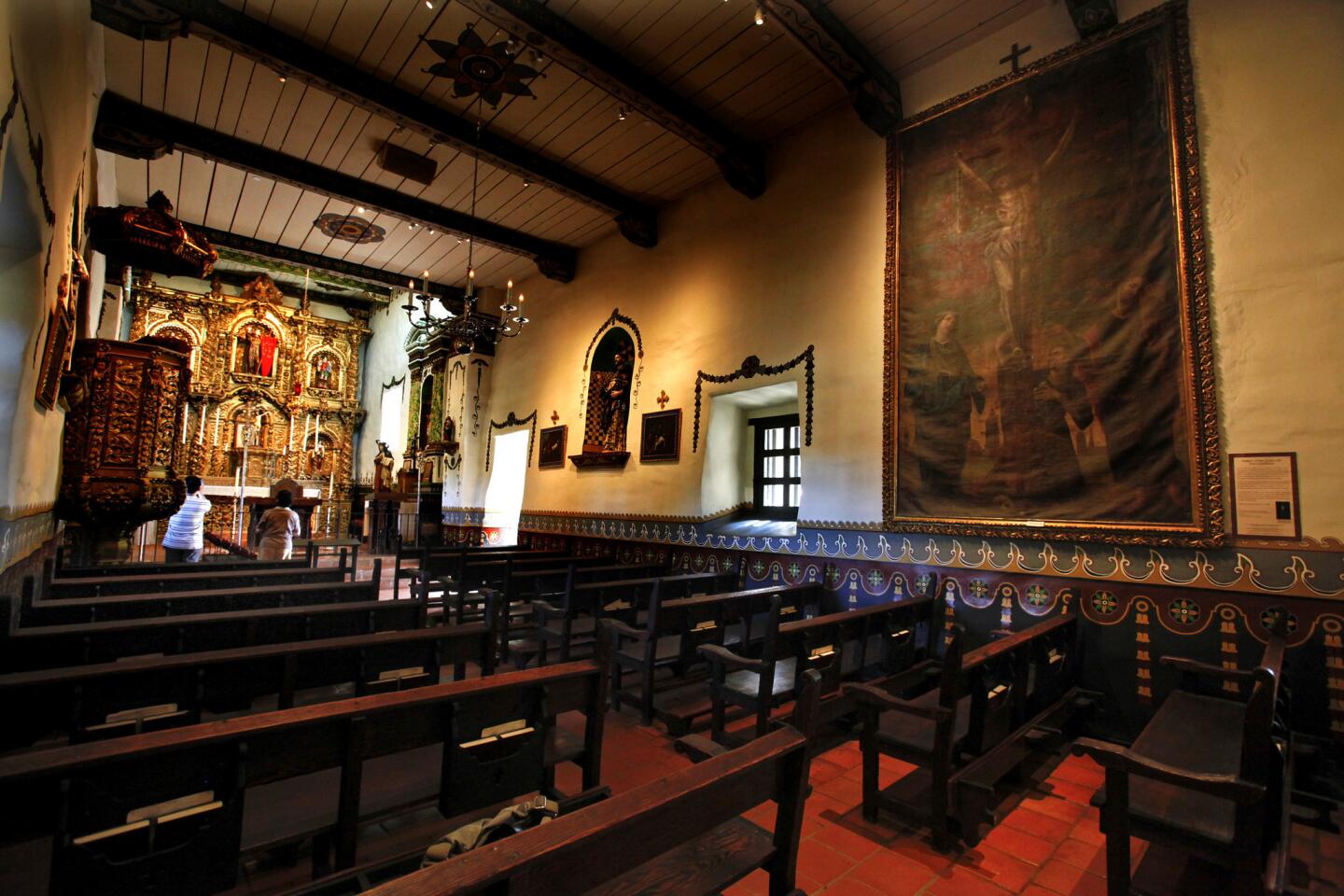 The 213-year-old painting of the Crucifixion currently hanging in the Serra Chapel (right) at Mission San Juan Capistrano was only recently revealed. It is believed to have been brought to the mission from Mexico.